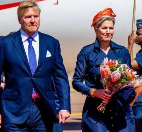 Η υπέροχη γκαρνταρόμπα της Βασίλισσας Μάξιμα για το ταξίδι στη Νότια Αφρική - Κατέφτασε με bleu marine trenchcoat & πορτοκαλί καπελάκι